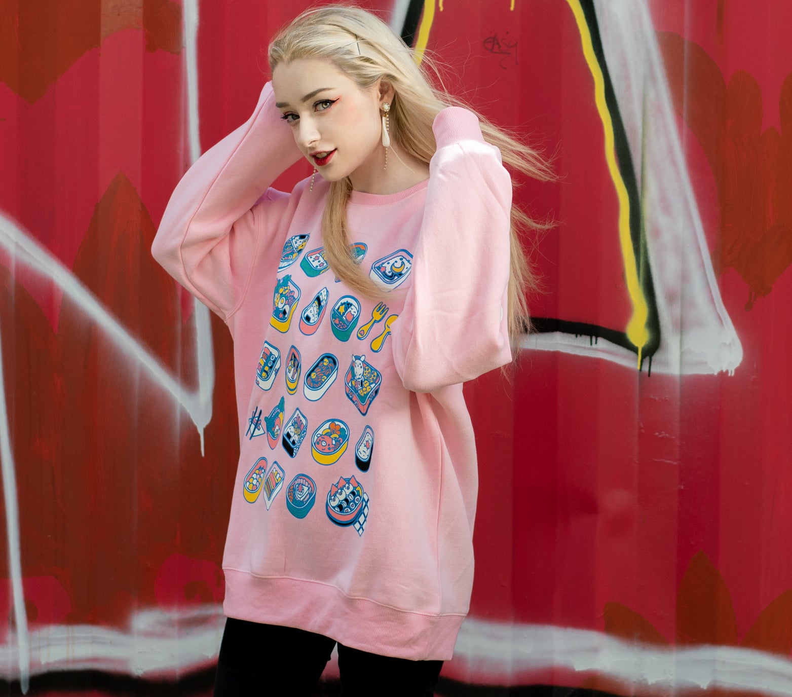 Light pink sweatshirt in an ultra soft exterior jersey fabric with a warm fuzzy interior. The front design of the sweatshirt are sets of cute bento lunches