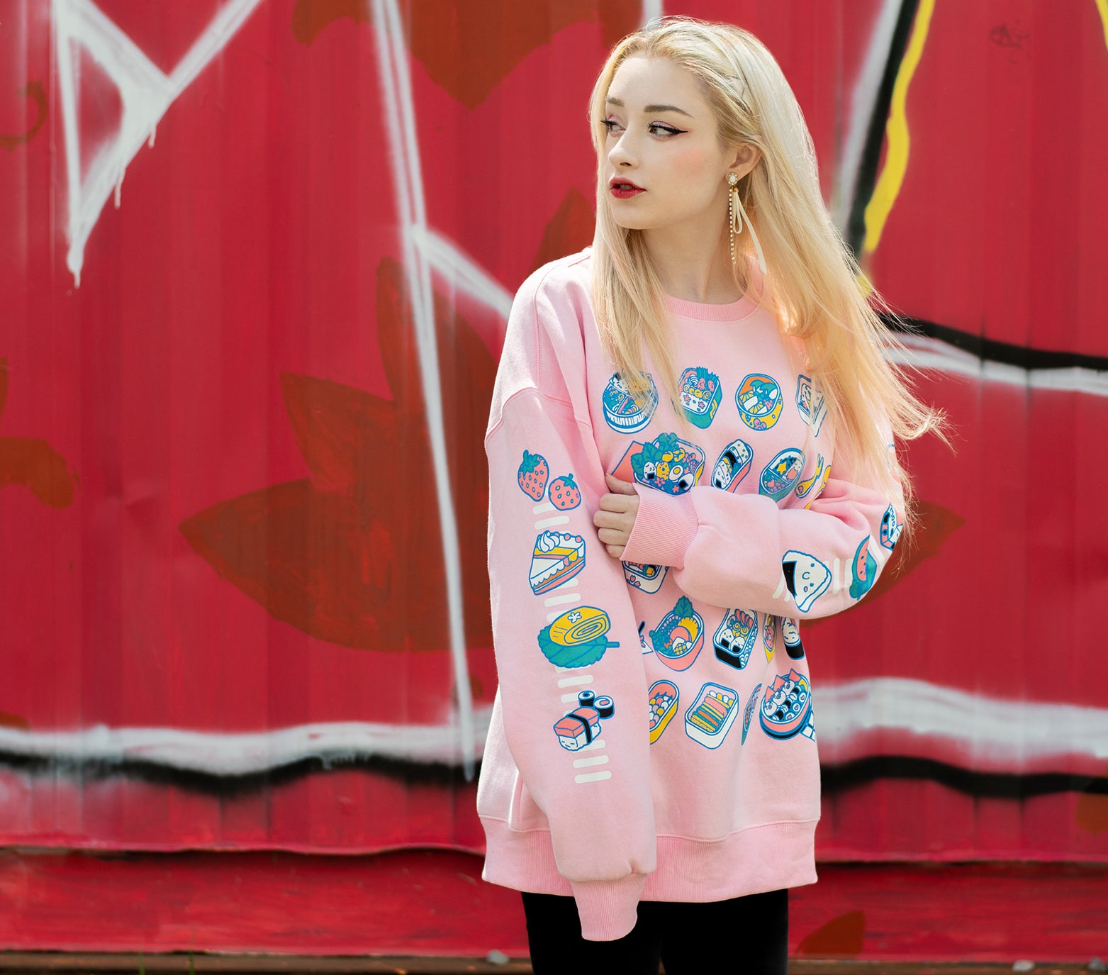 Light pink bento box sweatshirt in an ultra soft exterior jersey fabric with a warm fuzzy interior. Model is displaying right sleeves while looking right.
